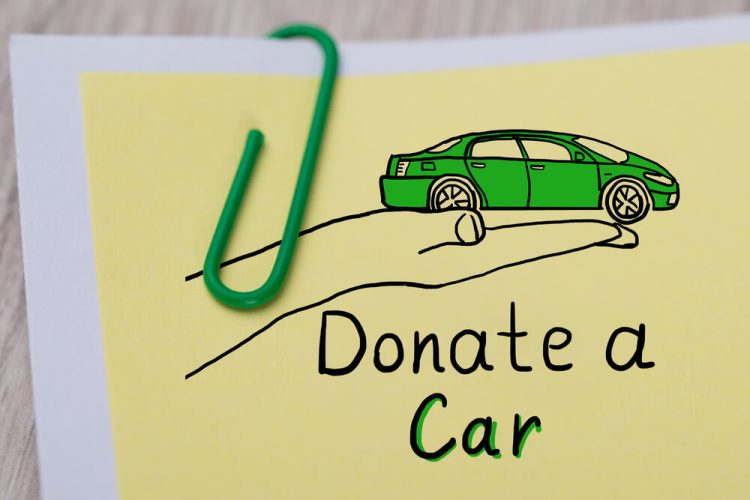 A note with a green paper clip that says Donate a Car.