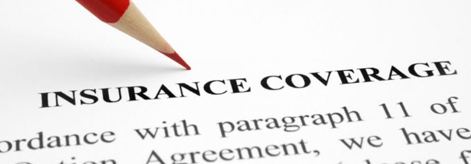 A red pencil writing on top of an insurance coverage application to illustrate auto-insurance application mistakes that might cost you.