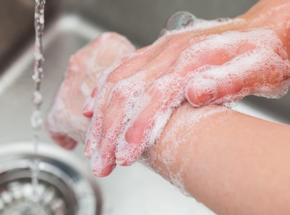 person washing hands to prevent coronavirus
