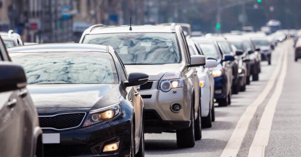 Shot of a long line of cars due to traffic on a road.