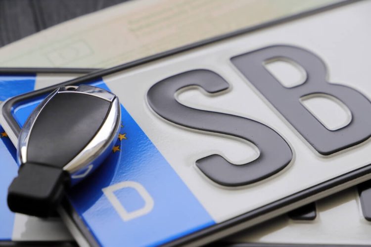 Car keys on top of a registration plate