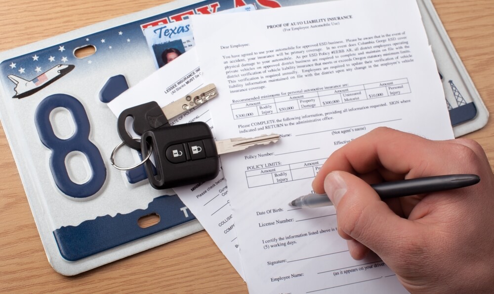 Writing a check, human hand with a pen and keys.