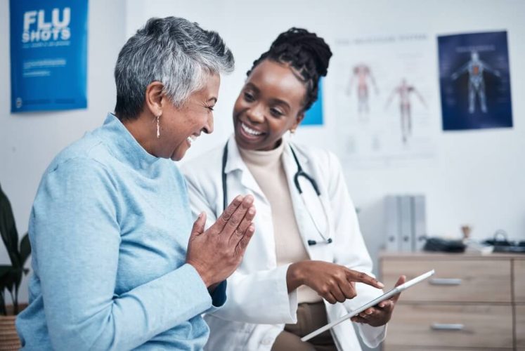 Doctor talking with her patient - freeway, cheap auto and health insurance