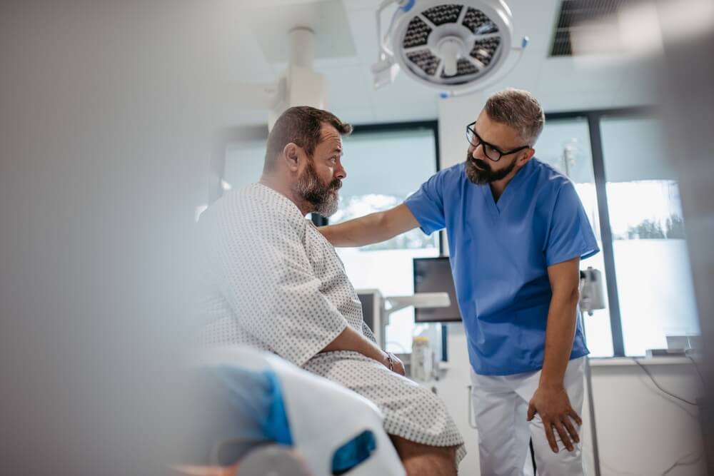 Supportive doctor soothing a worried patient