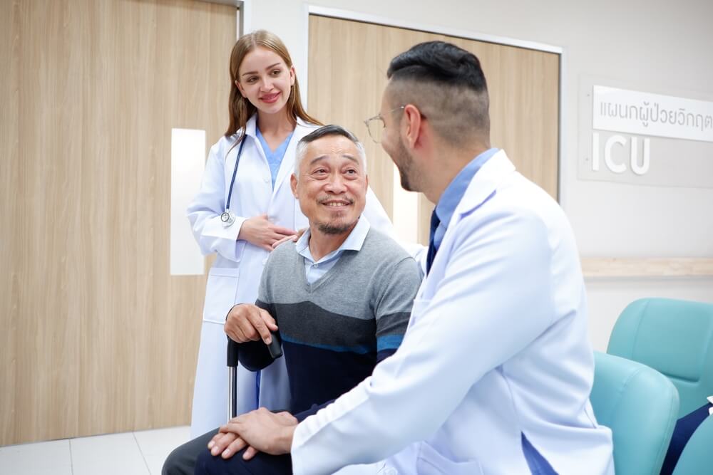 Old man with a doctor and female doctor after having a medical plan from Covered California during the Open Enrollment period