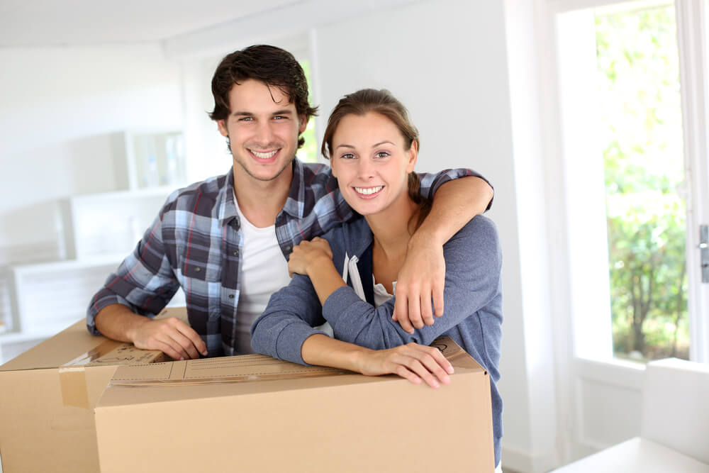 Young couple renters moving in their boxes.