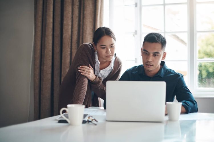 Couple looks over their home insurance policy - cheap homeowners insurance.