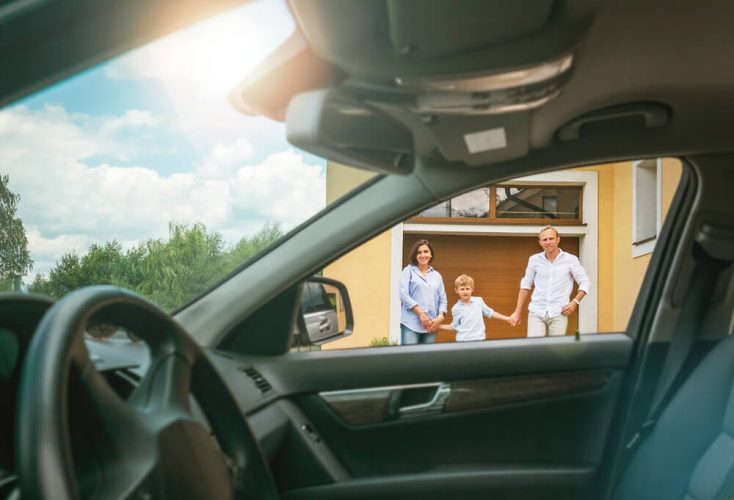 Young family comes out of door of house towards their car - cheap car and home insurance.