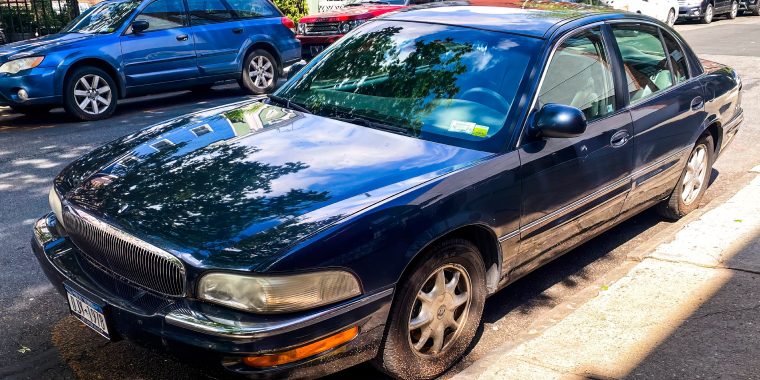 A blue Buick Park Avenue full-size sedan parked on the street.